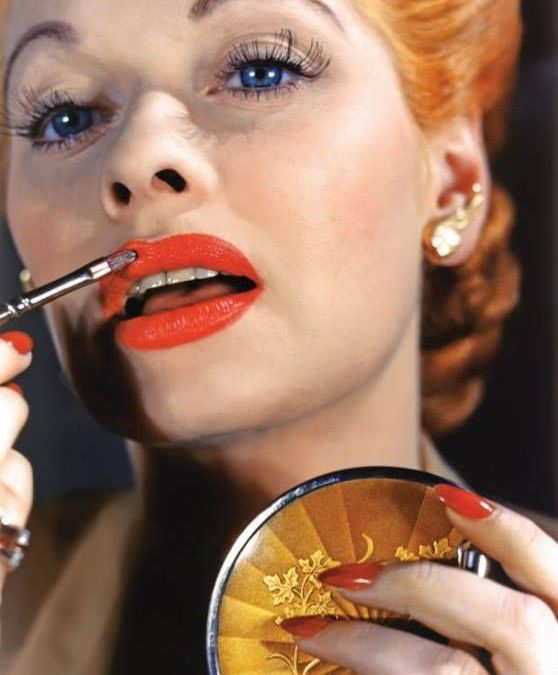 Woman Putting On Lip Gloss