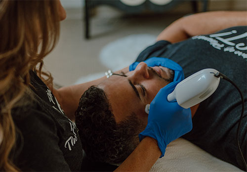 man getting jet plasma treatment on his face
